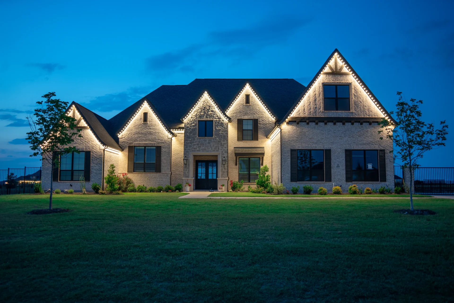 Same home at night with accent & architectural lighting