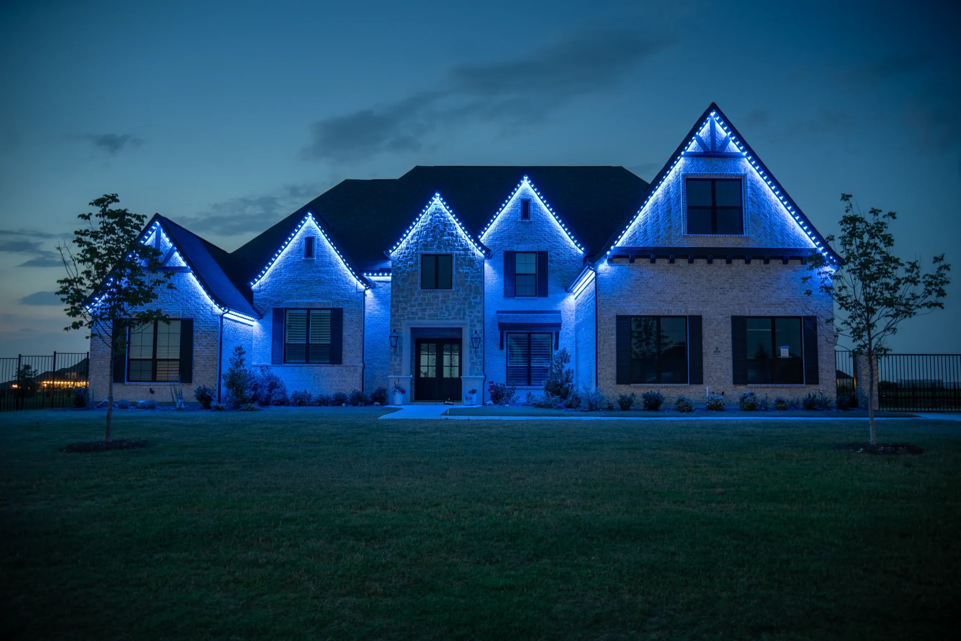Same home at night with game day lighting