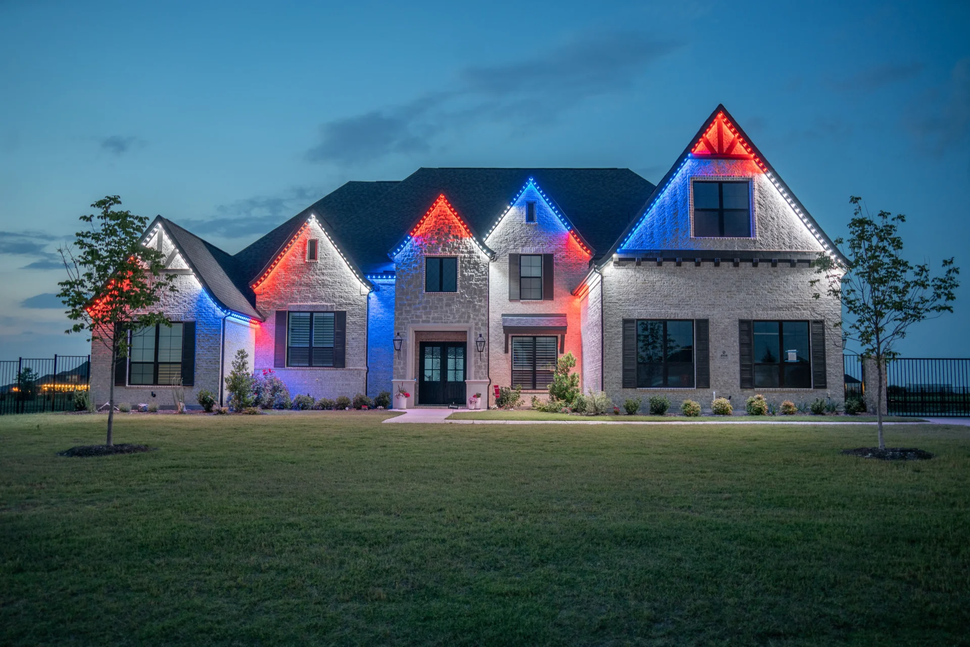 Same home at night with holiday lighting